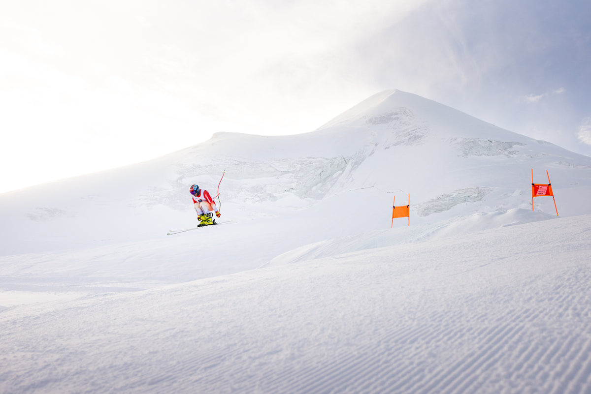 Livio Hiltbrand passing a gate with the summit behind