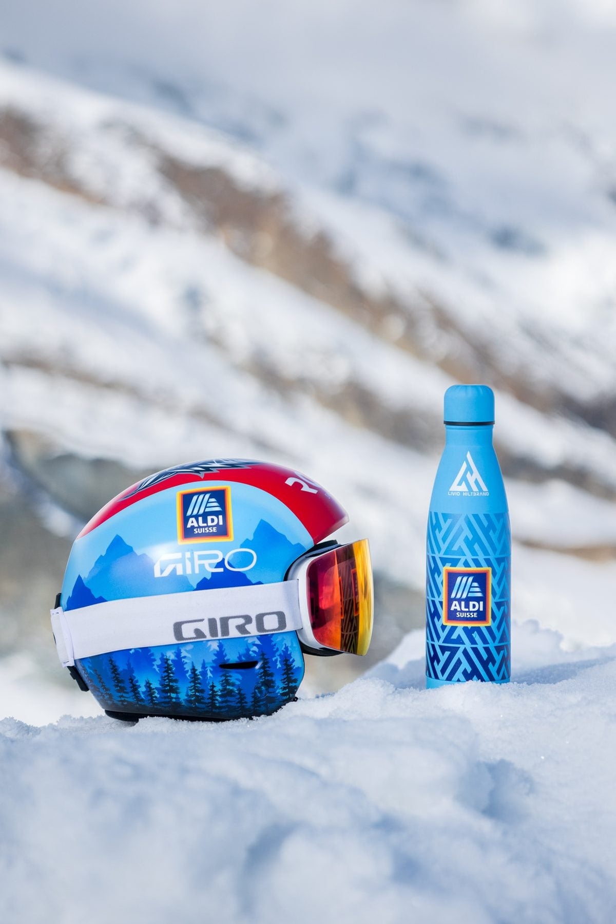 Helmet and Aldi Suisse bottle in the snow