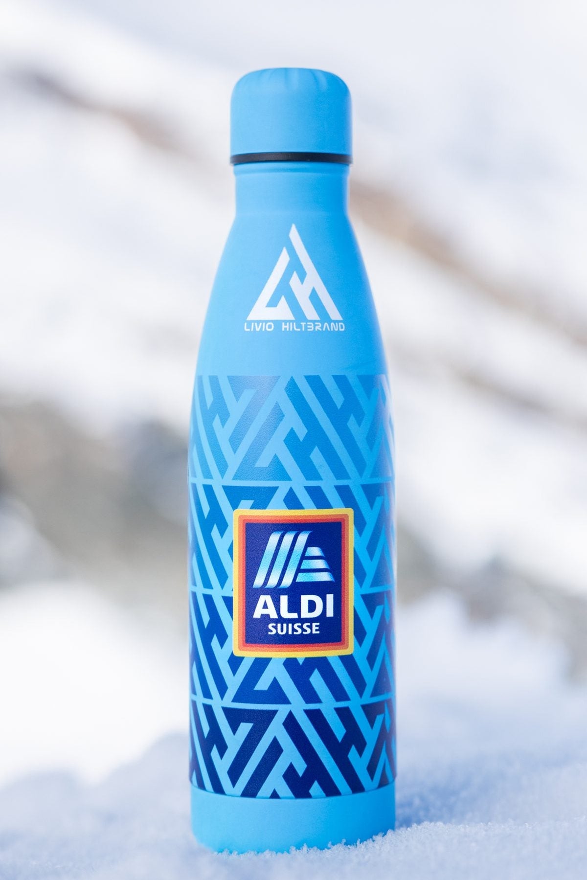 Aldi Suisse bottle standing in the snow