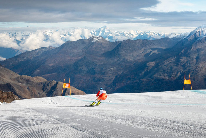 Livio Hiltbrand small in the wide glacier landscape above the clouds