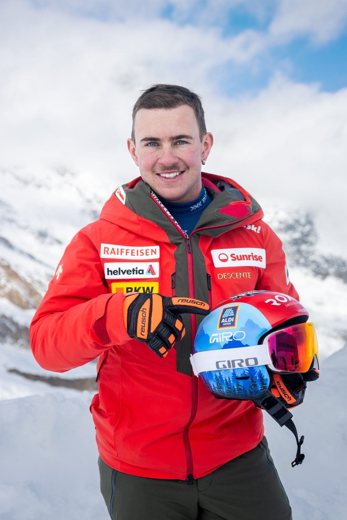 Livio Hiltbrand holding his helmet, smiling