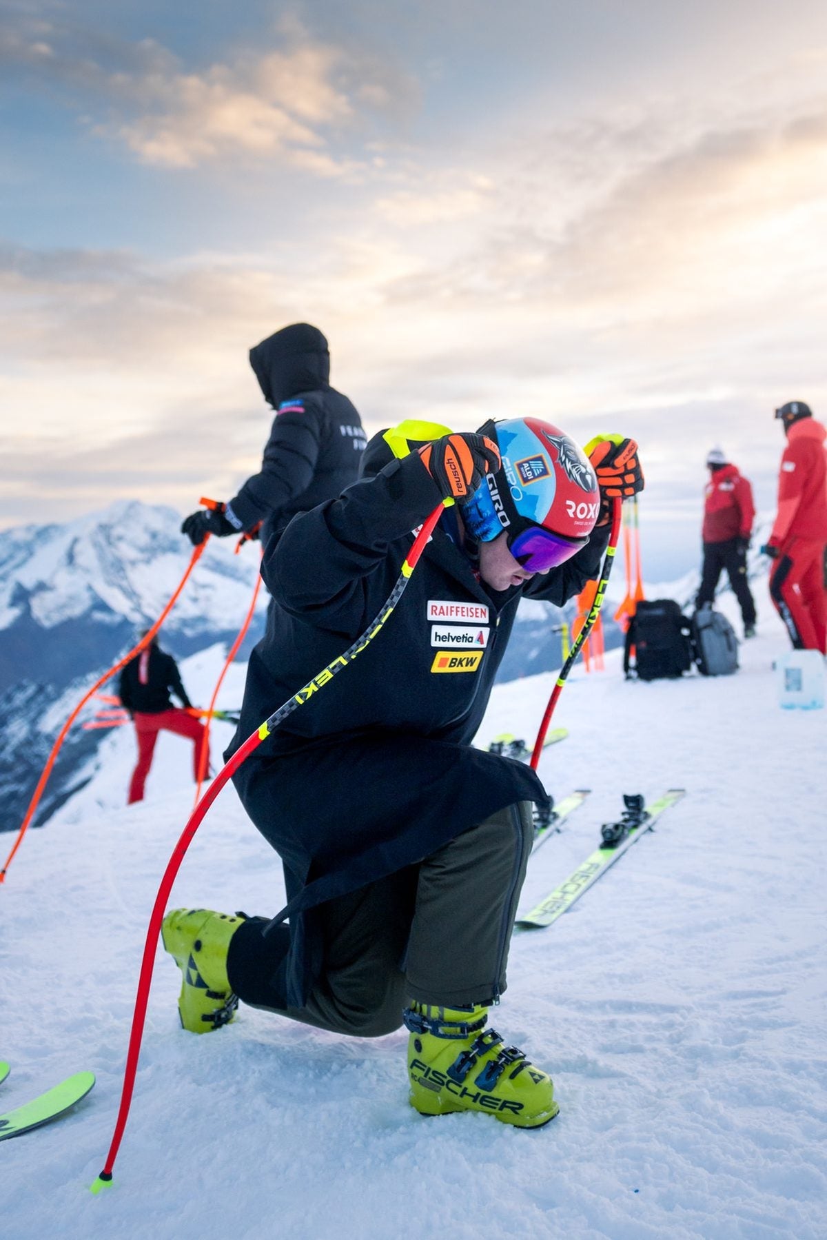 Athletes and coaches preparing skis before the run