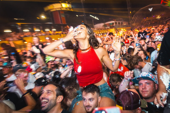 Visitor on someone's shoulders eating cake during a cake fight