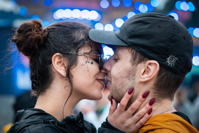 Couple about to kiss in front of blue stage lights