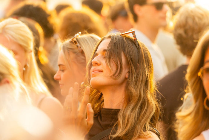 Visitor with closed eyes enjoying the music in golden light