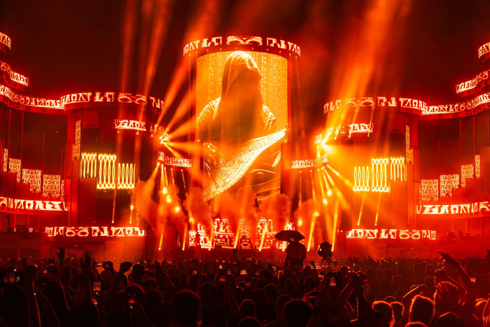 Main stage in deep red light with beams cutting through the smoke