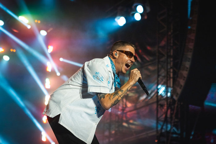 Singer performing close to the camera in blue and red beams