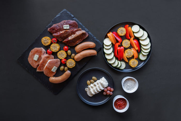 Barbecue platter with meat, vegetables and dips from above