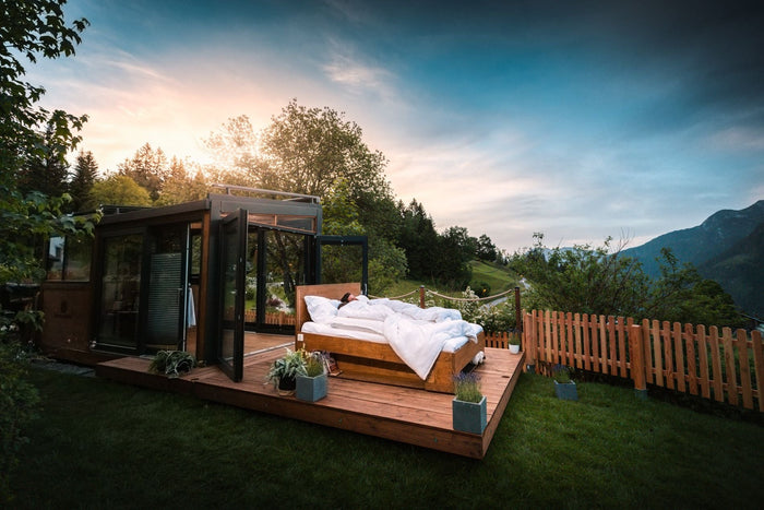 Guest sleeping in an outdoor bed at sunrise