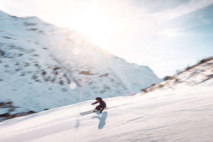 Skier at speed in backlight, captured with a slow panning shot