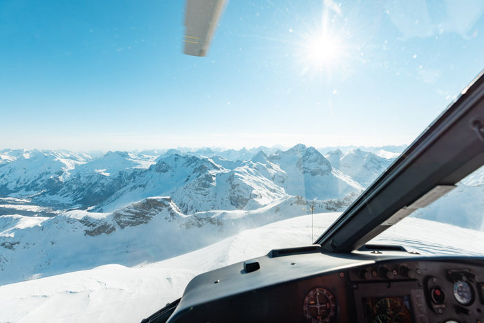 View from the helicopter cockpit over the snowy Arlberg mountains