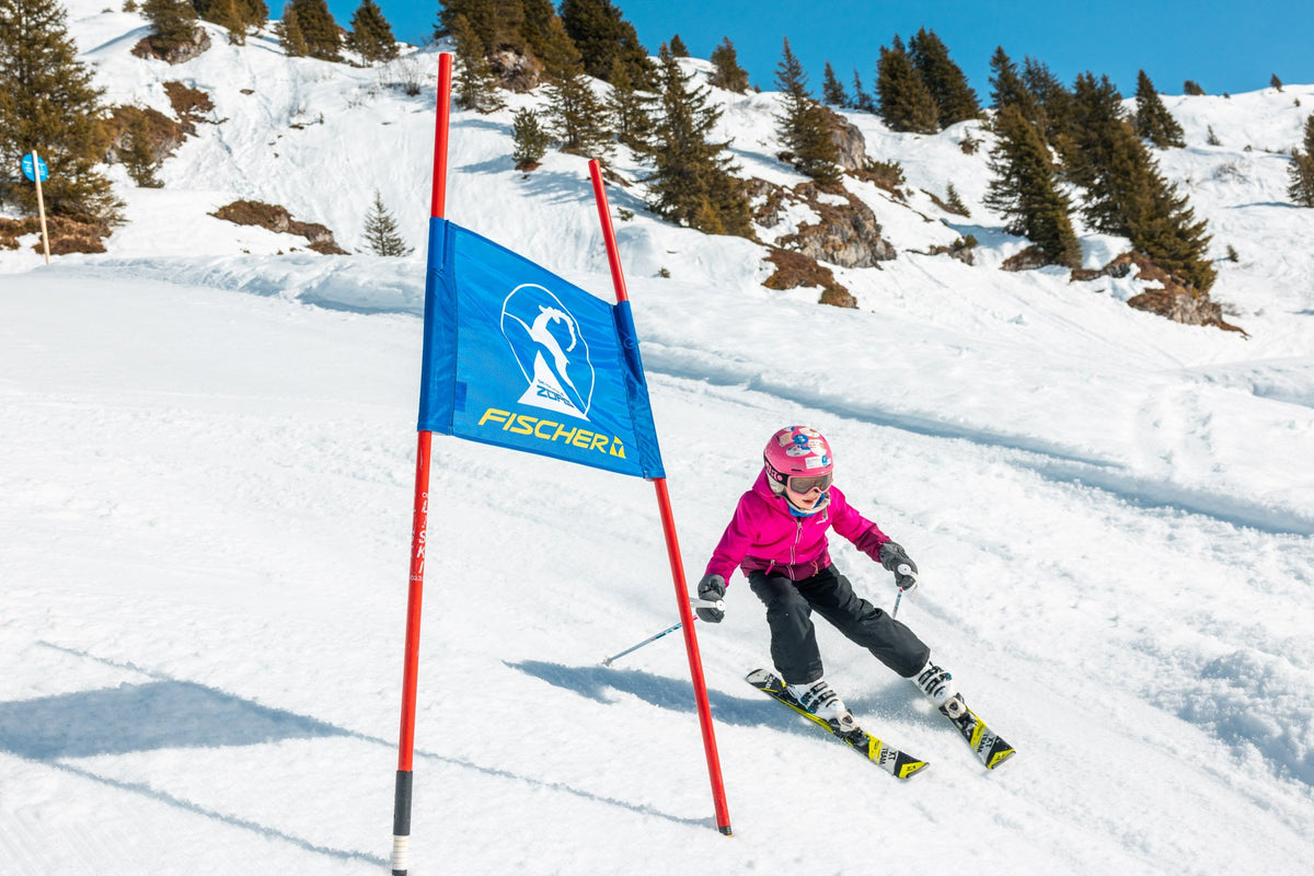 A young skier passing a race gate