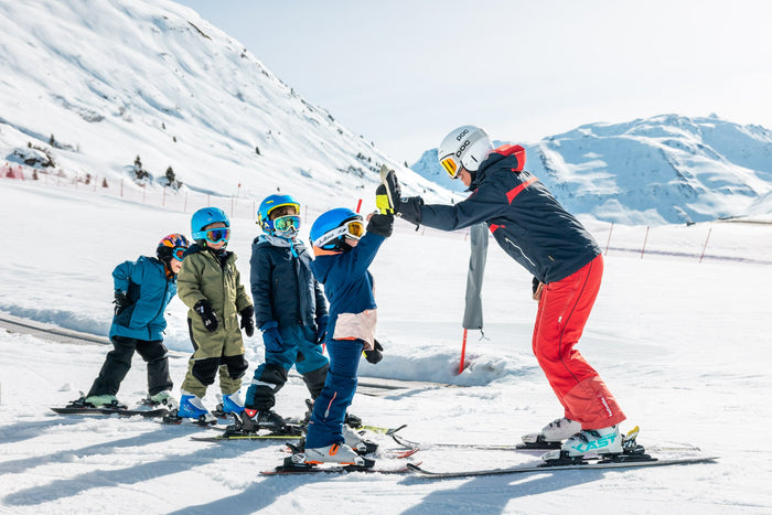 Children giving their ski instructor a high five