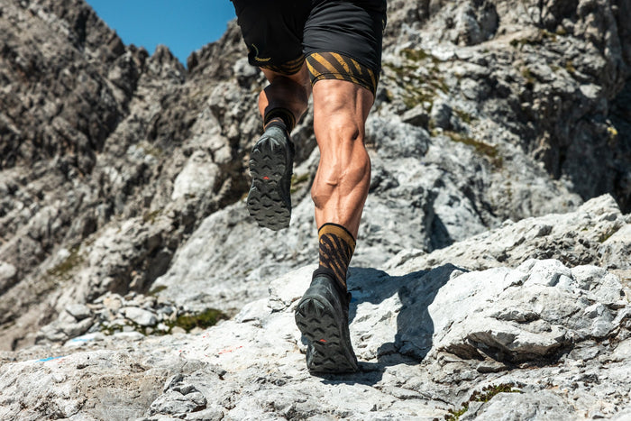 Close up of a trail runner stepping over rocks