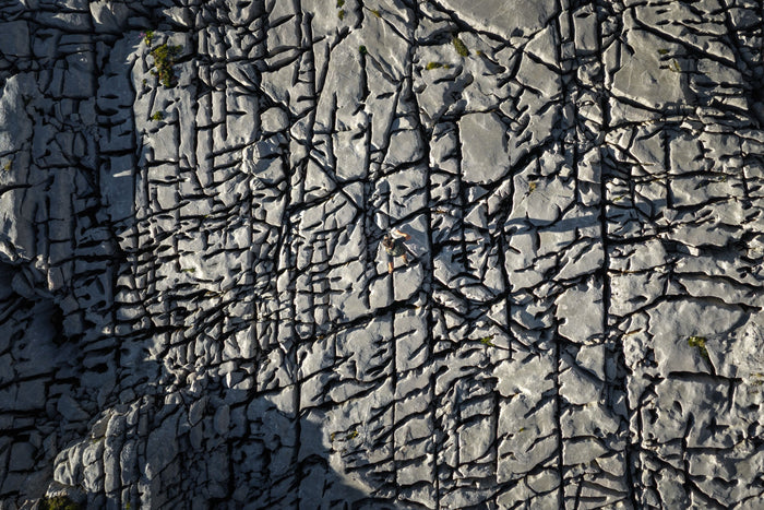 Top down drone view of a runner on cracked karst limestone