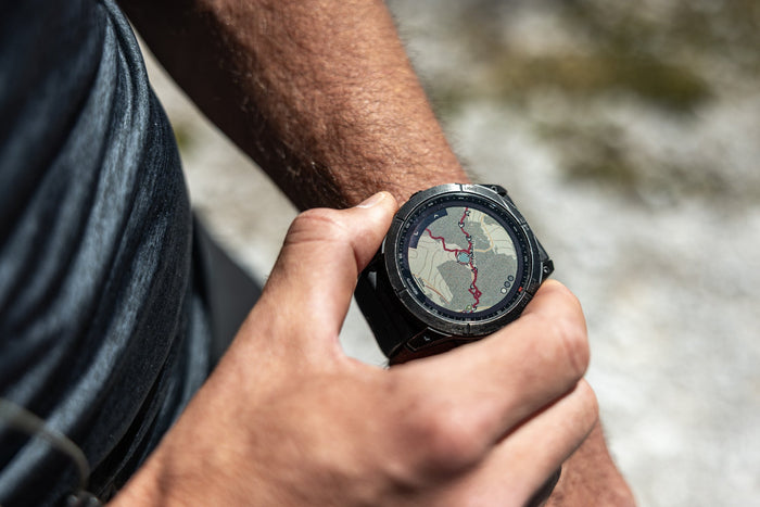 Trail runner checking the route map on a GPS watch